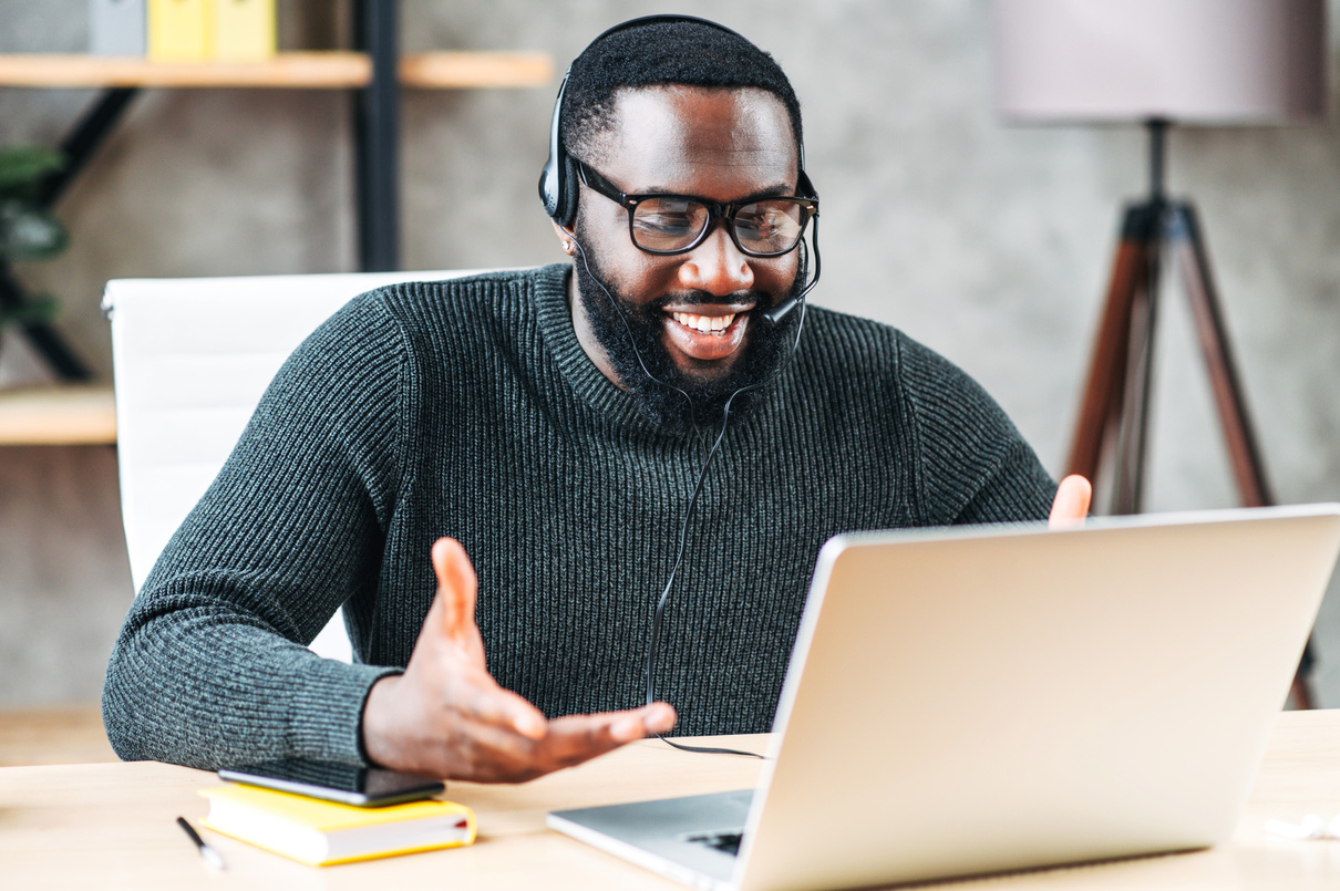 African-American guy with headset using laptop